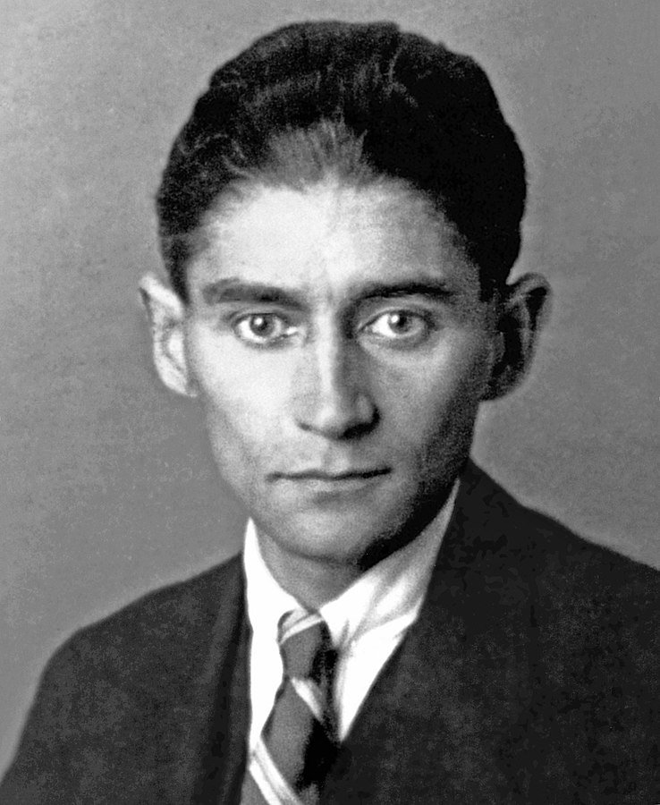 Black and white photo of Franz Kafka wearing a suit