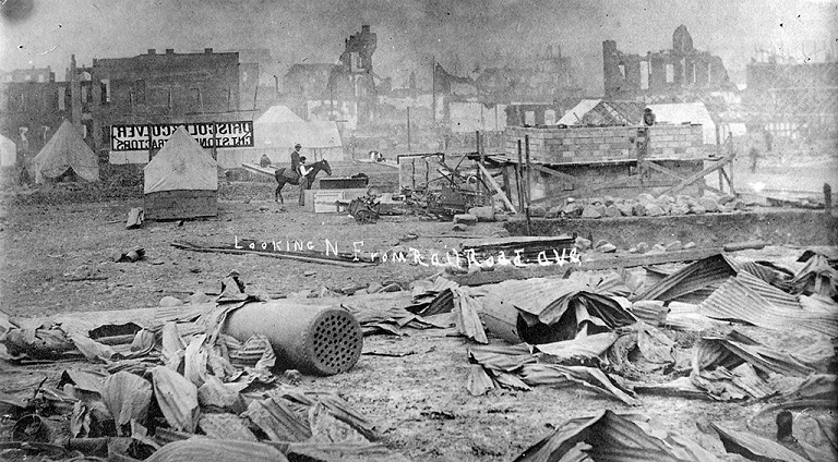 Black and white photo of burned buildings and debris after Spokane Falls Fire