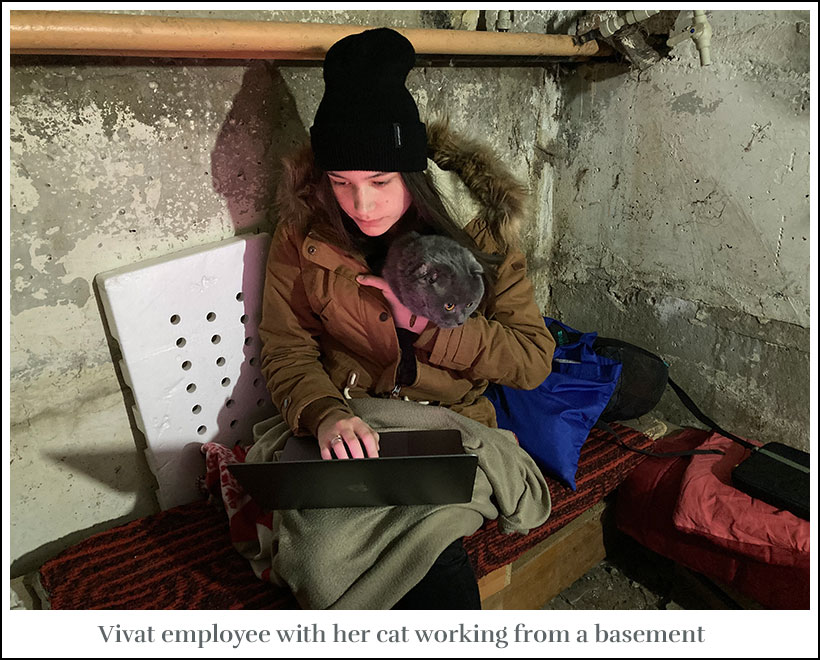 Vivat employee and her cat working from a basement
