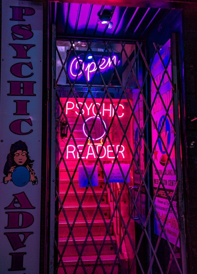 Neon signage in doorway advertising psychic services