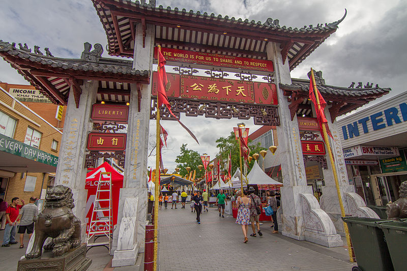 Cabramatta Pai Lau Gate in Freedom Plaza with shops and market stalls in background