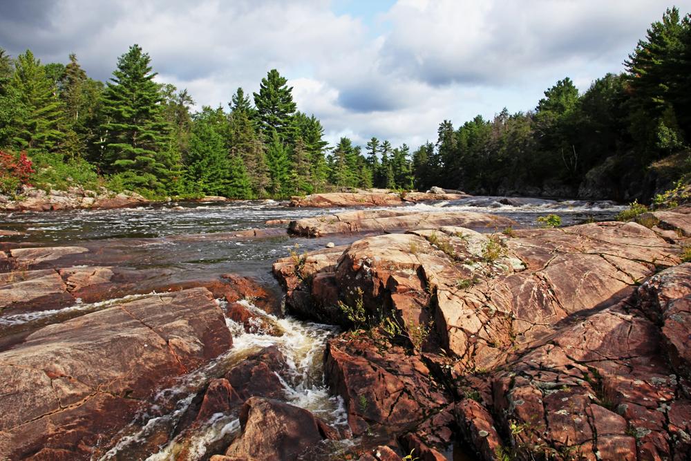 River surrounded by rock formations and trees in the Canadian Shield