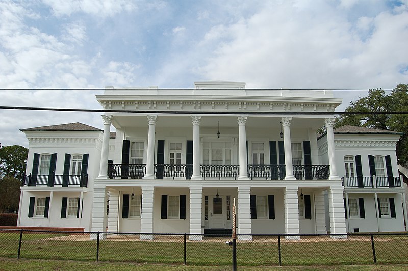 2011 photo of the site where the Carville facility was located, showing a wide, white two-story building with pillars on both levels