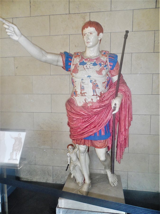 Modern imagining of how a classical statue may have been colored, depicting a barefoot man with staff and pink-and-blue garments