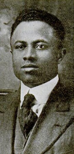 Black-and-white photo portrait of Frazier as a young man in suit and tie