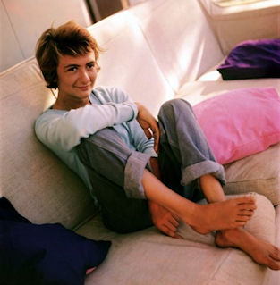 Francoise Sagan as a teenager sitting on a couch