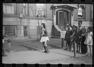 Black and white photograph of girls jumping rope