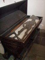A preserved body on display in glass