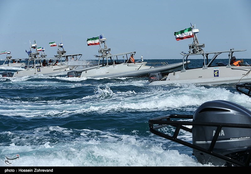 IRGC speedboats in the water flying the Iranian flag