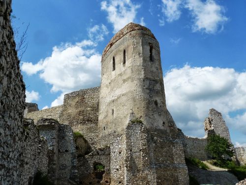 Tall stone tower of a castle against blue sky