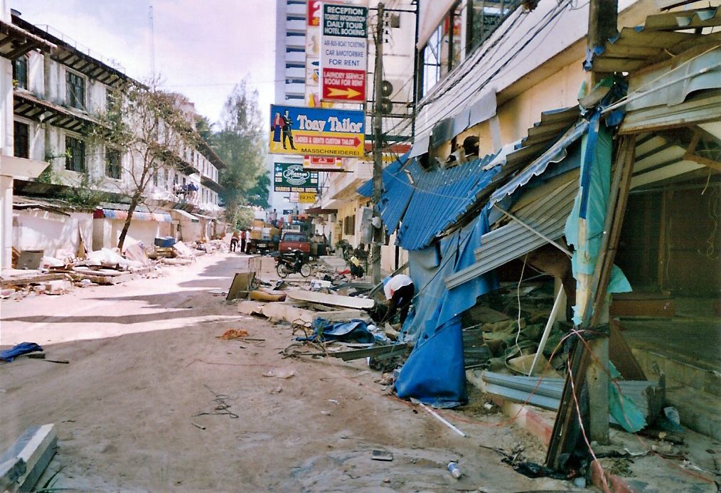 Photo view of broken-down building and street covered in debris