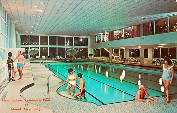 Promotional photo depicting three couples enjoying an indoor swimming pool