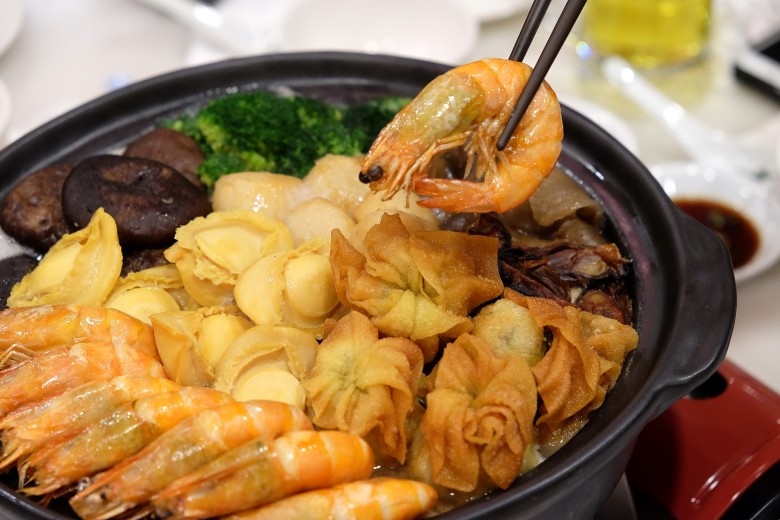 Poon choy, featuring prawns, broccoli, oysters, fried dumplings