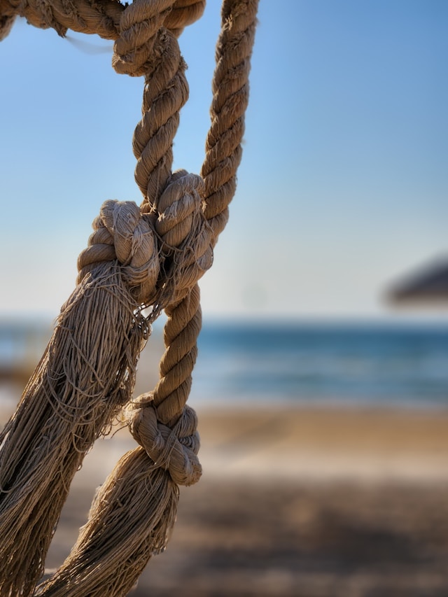 Close-up of a knotted rope on a beach