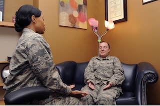 Two US Air Force members practice relaxation therapy