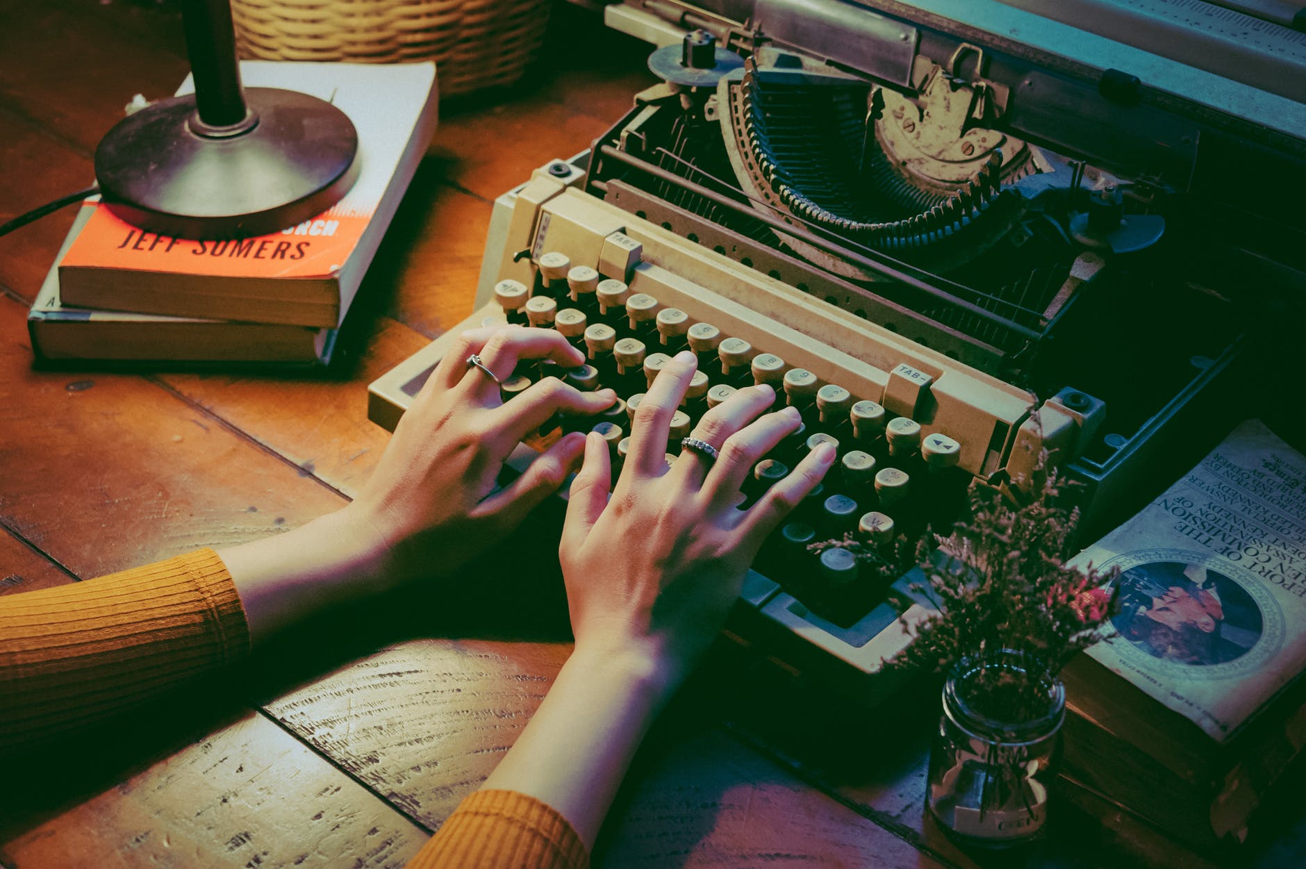 Hands typing on a typewriter