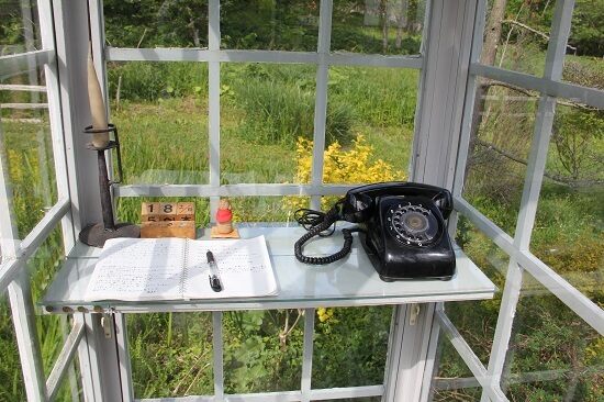 Glass phone booth with disconnected rotary phone