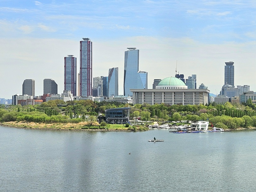 Panoramic view of Yeouido skyscrapers and the National Assembly building from Dangsan Bridge with Han River in foreground